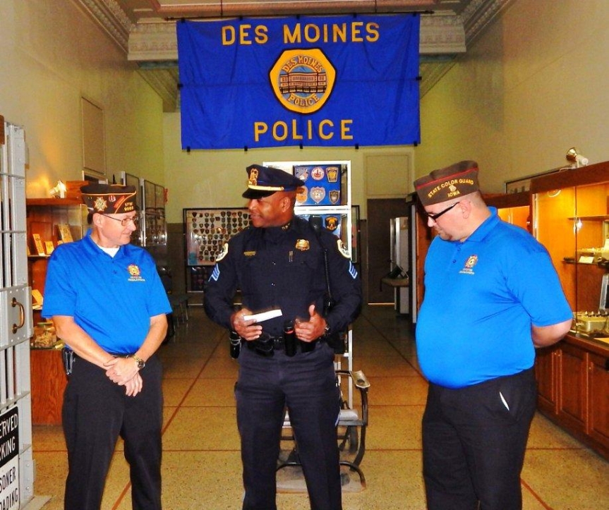 Senior Vice Dennis Applehous and Junior Vice Chris McClaskey present a donation check to Des Moines police Sgt. Bernell Edwards.